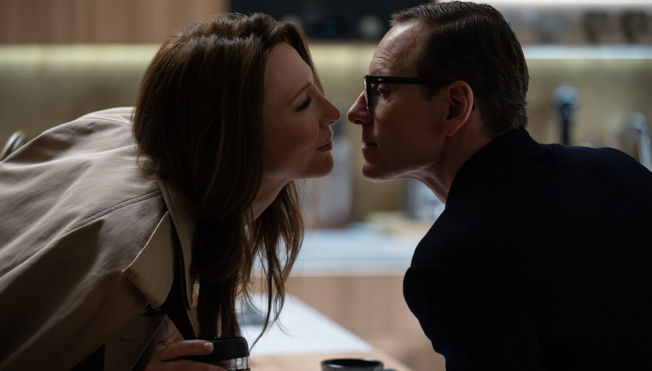 Cate Blanchett and Michael Fassbender as husband and wife spies leaning in for a kiss in Black Bag.